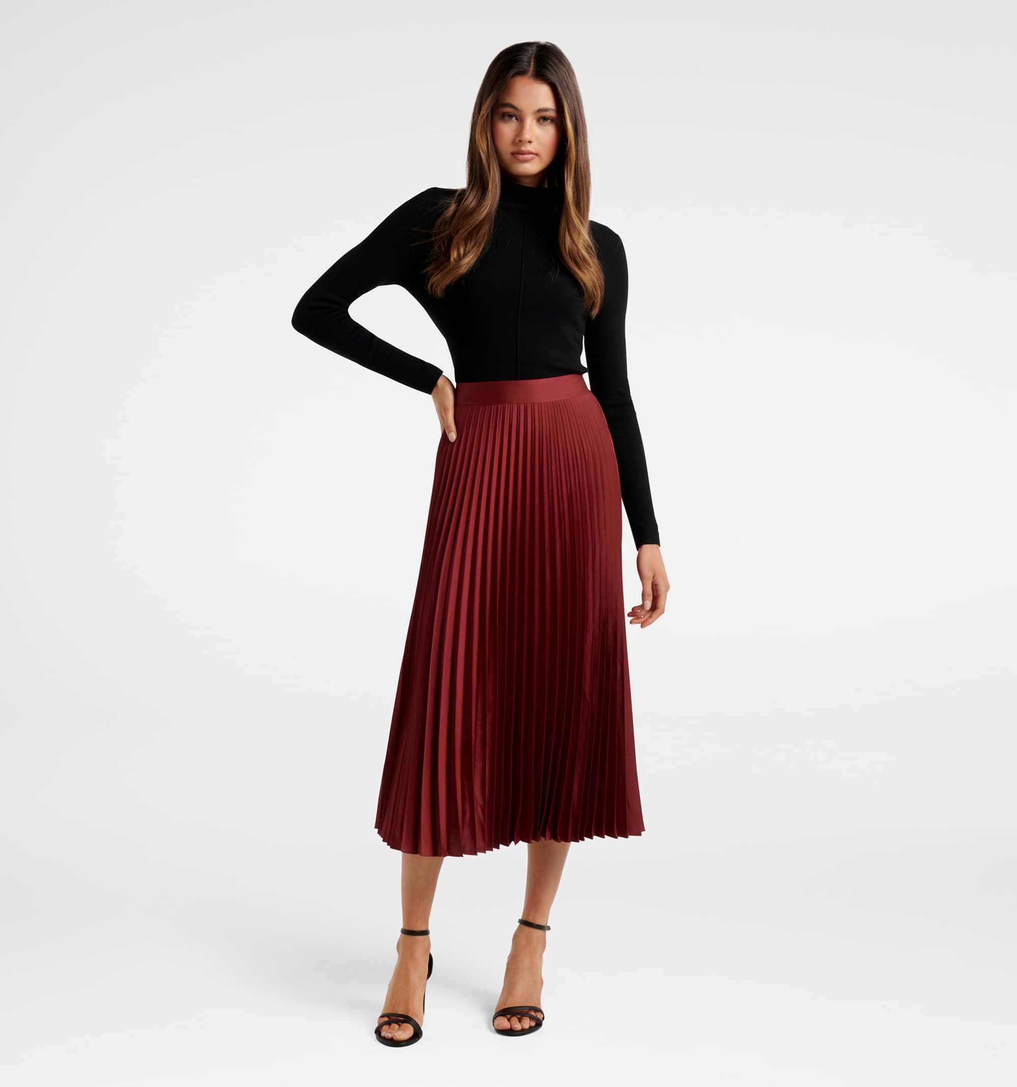 Forever New - Spinning Around: Elegant pleated midi skirts in classic tones  like taupe work back with statement knitwear and tops. Shop the Britton  Cold Shoulder Knit Jumper and Ester Sati Pleated